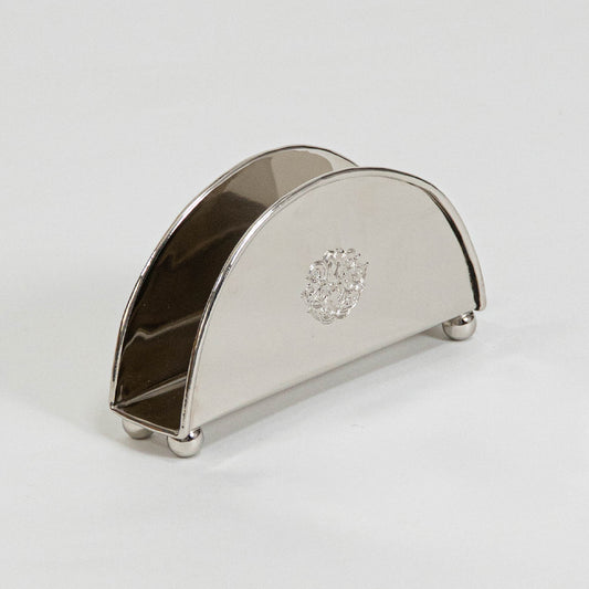 Modern metal napkin holder in silver finish for dining table or kitchen decor accessory placement white background.
