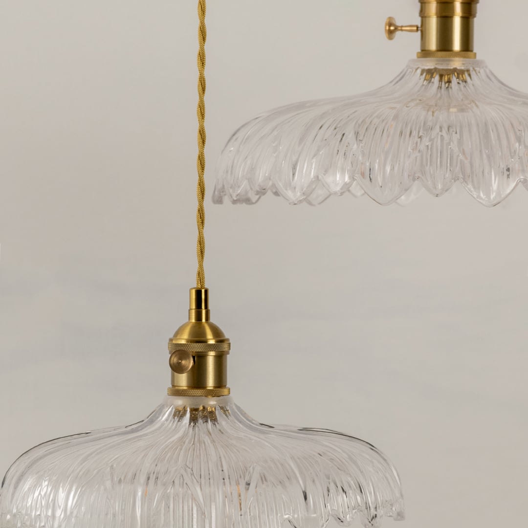 Clear textured glass pendant light illuminated to display luxury ceiling lighting with refined contemporary styling.