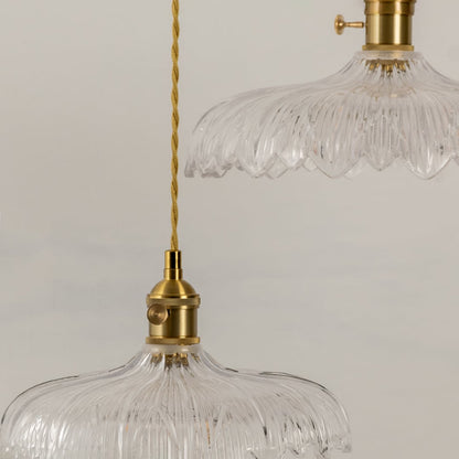 Clear textured glass pendant light illuminated to display luxury ceiling lighting with refined contemporary styling.