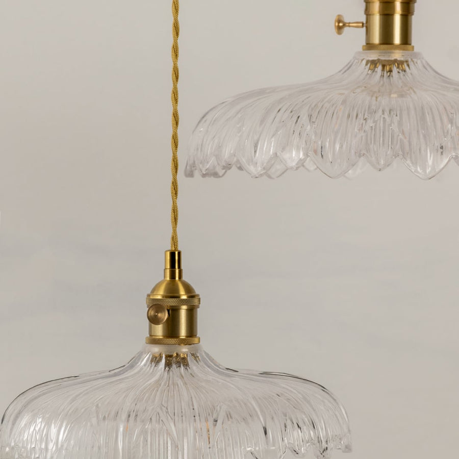 Clear textured glass pendant light illuminated to display luxury ceiling lighting with refined contemporary styling.