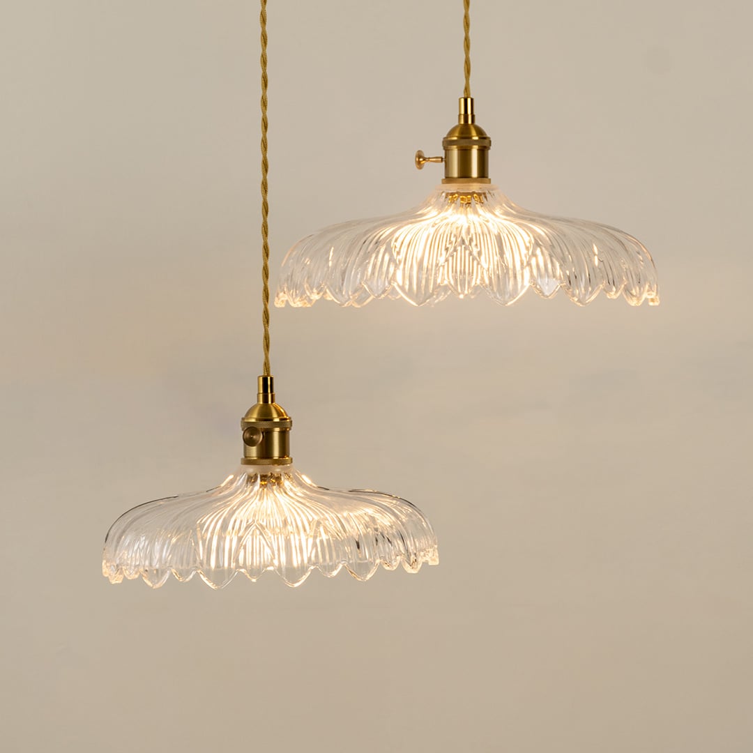 Clear textured glass pendant lights illuminated to highlight premium decorative ceiling lighting and elegant craftsmanship.