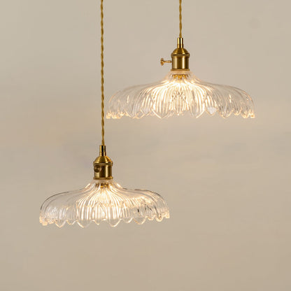 Clear textured glass pendant lights illuminated to highlight premium decorative ceiling lighting and elegant craftsmanship.