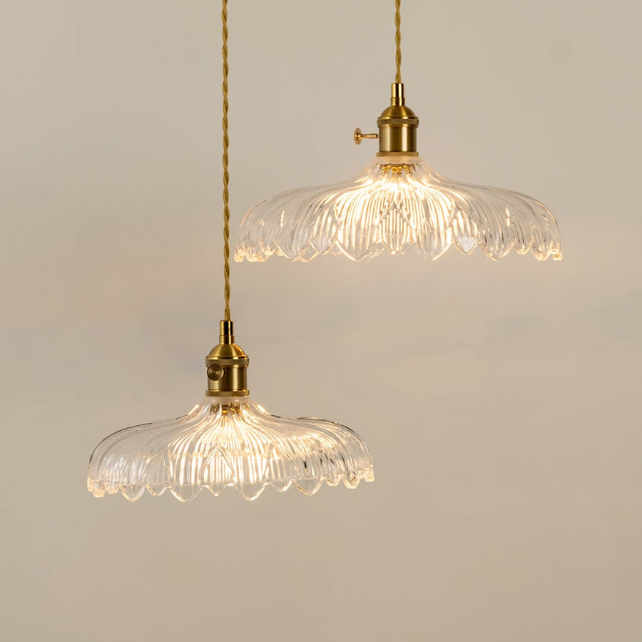 Clear textured glass pendant lights illuminated to highlight premium decorative ceiling lighting and elegant craftsmanship.