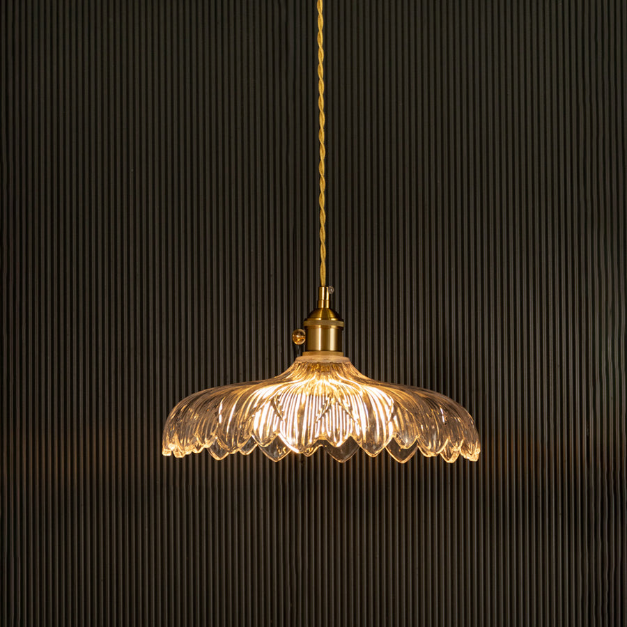 Crystal glass pendant light with gold metal accents glowing beautifully for elegant dining spaces.