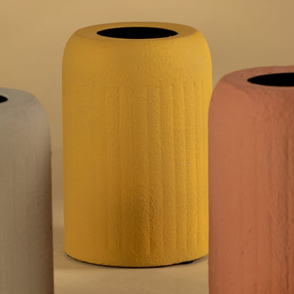 Closeup of black ceramic vase showing ribbed detailing and smooth matte texture for a bold contemporary decor accent.