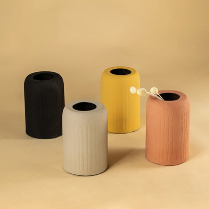 Set of terracotta textured ceramic vases displayed together creating a warm cohesive look for shelf and tabletop decor.