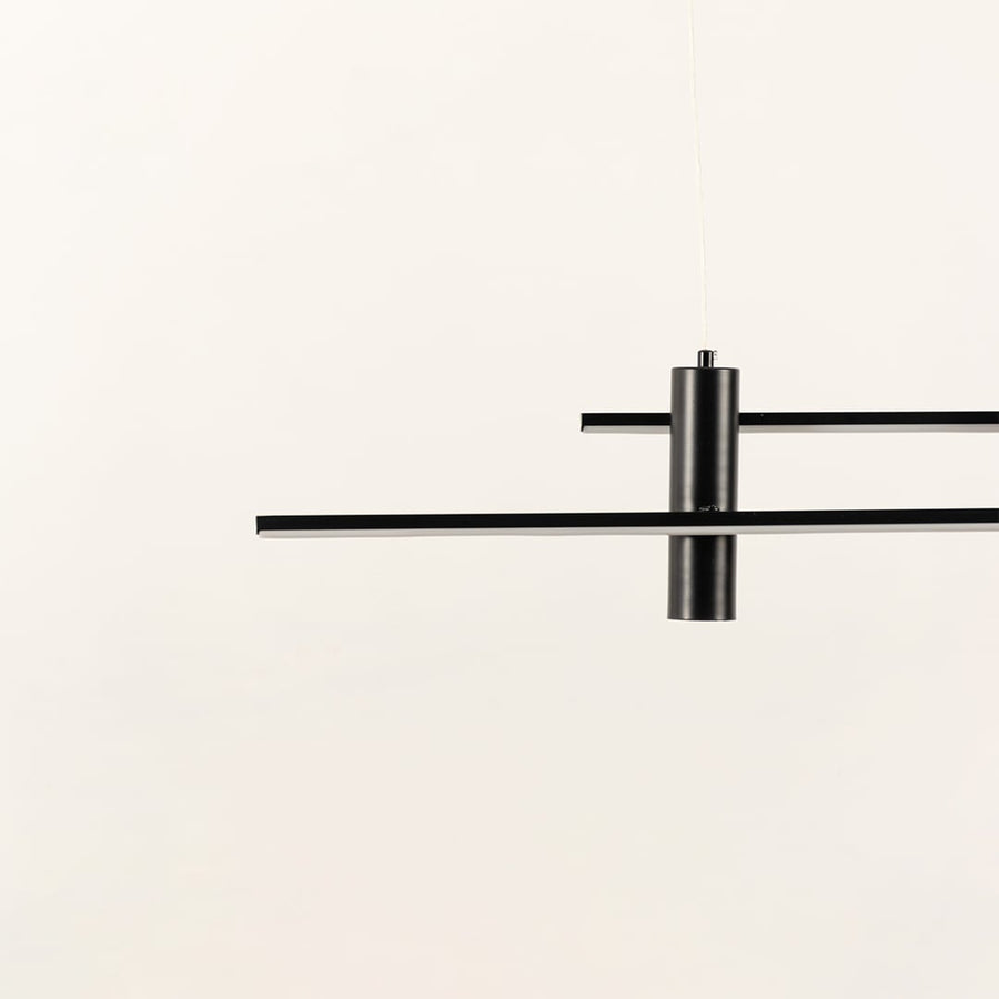 Minimal black linear pendant light with extended intersecting bars creating a balanced geometric silhouette that adds a sleek contemporary highlight to the interior.