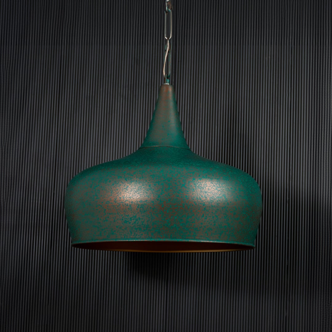 Green metal pendant light illuminated softly creating cozy ambiance in contemporary indoor spaces.