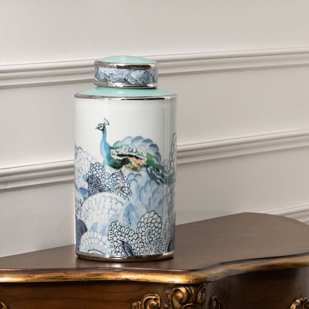 White ceramic decorative jar with blue ocean artwork displayed on a console table for luxury home decor styling.