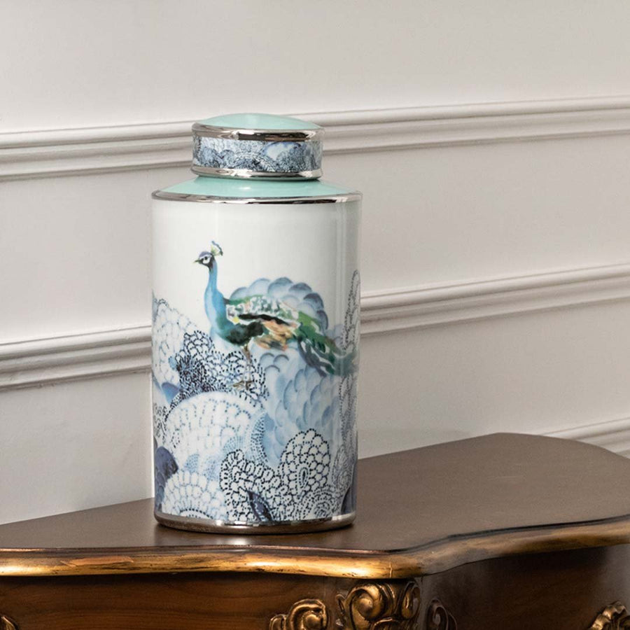 White ceramic decorative jar with blue ocean artwork displayed on a console table for luxury home decor styling.