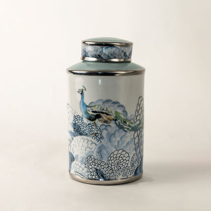 Blue and white ceramic jar with fish artwork shown on plain background for coastal inspired décor.