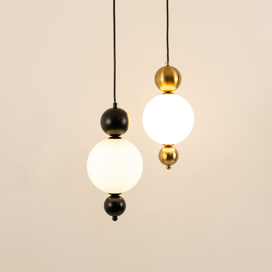 Black and gold metal wall lights illuminated to showcase sophisticated modern wall lighting with refined elegance.