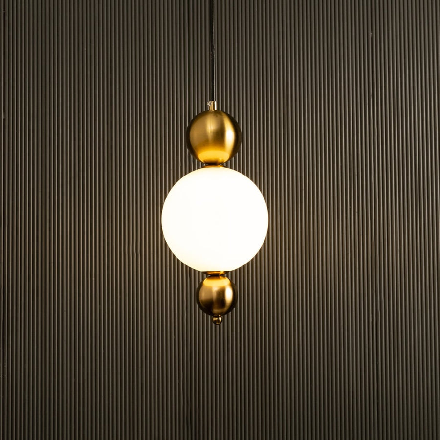 A contemporary white globe pendant with gold fittings ideal for LED suspension lighting and refined designer interior décor in modern living environments.
