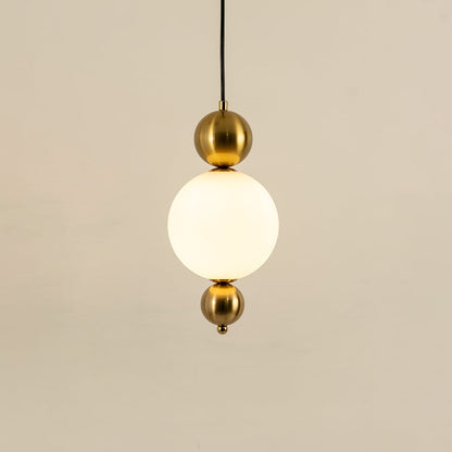 Gold metal wall light with frosted glass globe illuminated to showcase premium modern wall lighting design.