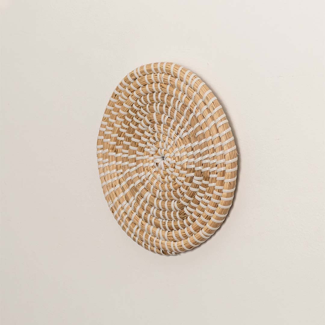 Side angle of woven wall plate highlighting its natural depth curvature and sturdy handwoven rim structure.