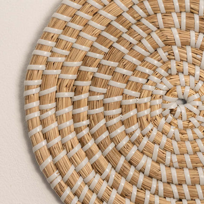 Detailed closeup of woven wall plate texture showing intricate handwoven fiber patterns and craftsmanship.
