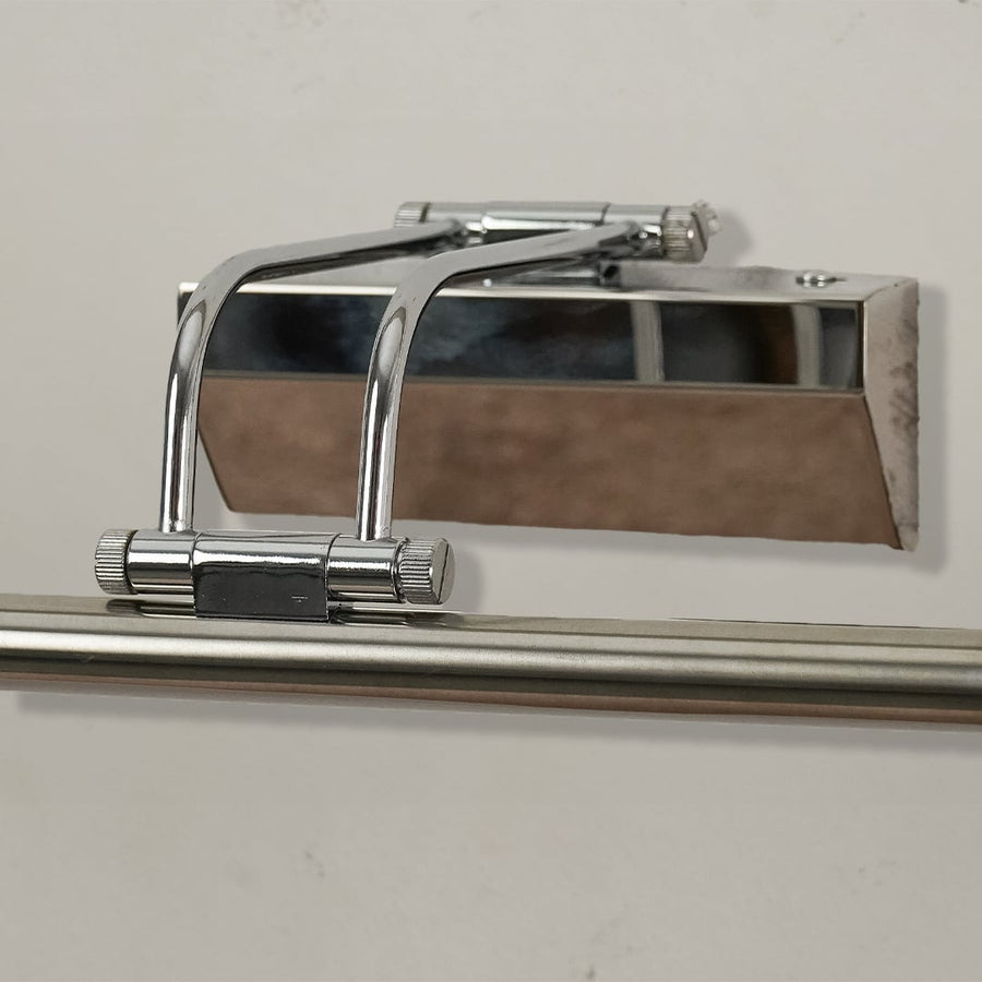 Closeup of chrome metal picture light showing polished finish slim bar design and warm directional illumination.