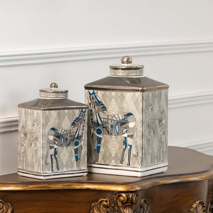 White and silver ceramic jars with embossed detailing ideal for luxury living room décor and refined console styling.