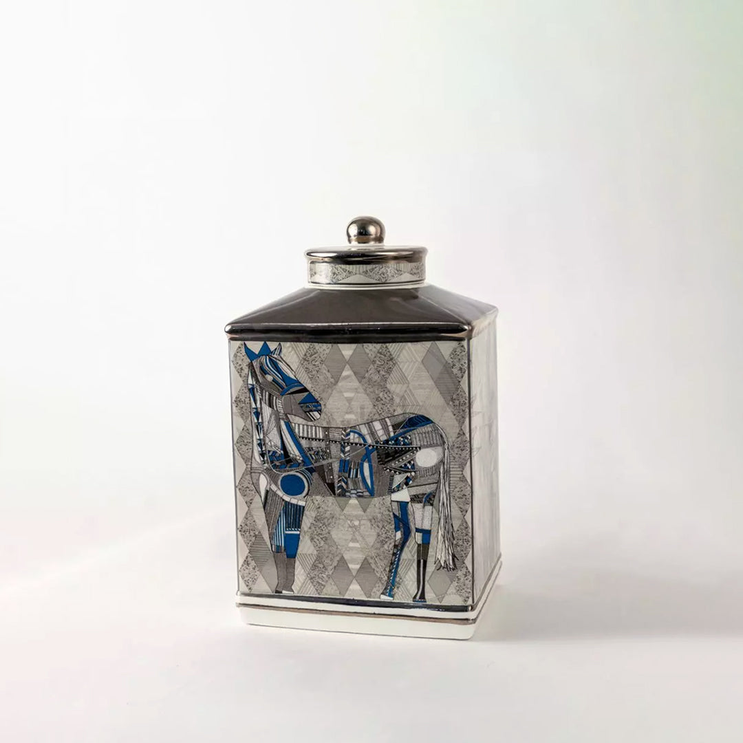 White ceramic decorative jar with blue horse artwork and silver lid for elegant tabletop styling and modern home decor.
