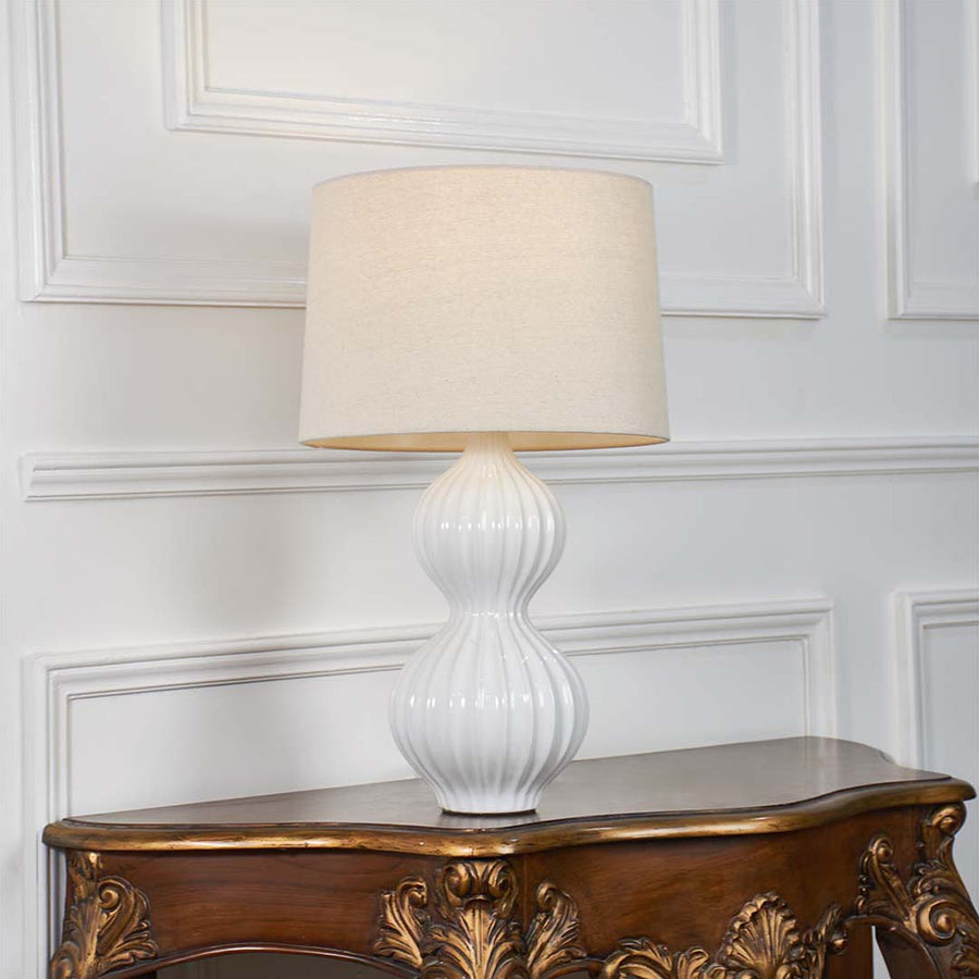 White textured glass table lamp with fabric shade crafted for sophisticated traditional decor and ambient table lighting.