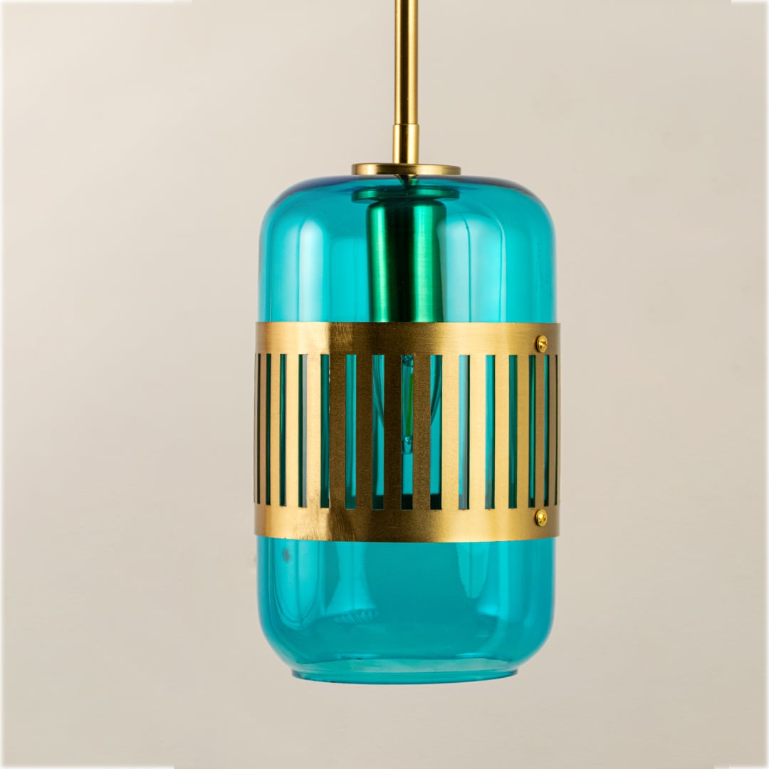 Close view of blue glass and gold metal wall light showing sleek texture and refined craftsmanship.