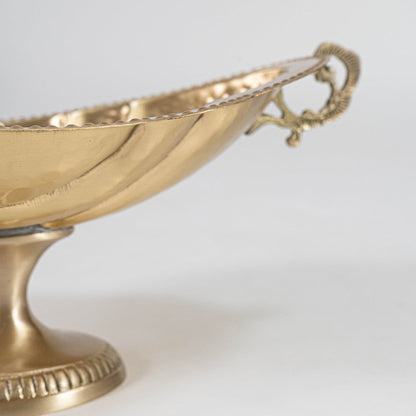 Elegant golden fruit bowl with textured finish packed in premium black gift box with logo branding on white base.