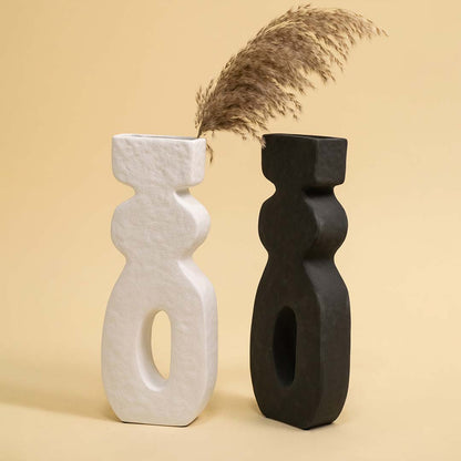 Set of black and white ceramic abstract sculptures with dried stems for artistic modern home decor displays.