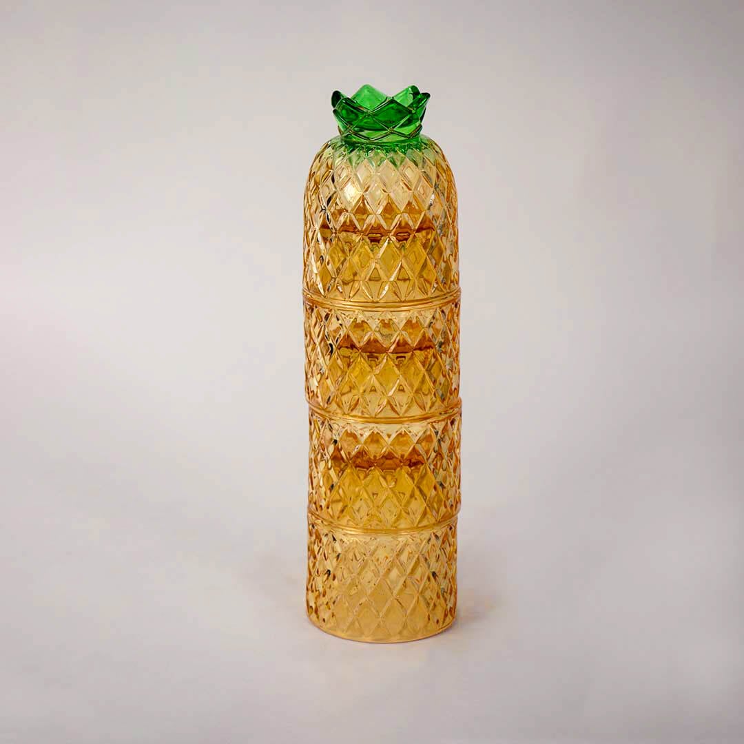 Decorative pineapple shaped amber glass tumbler set with textured diamond design and green lid for dining table styling.