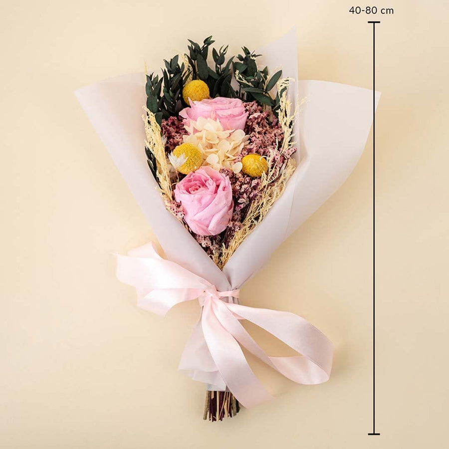 Flower bouquet dimensions 40 to 80 cm height with preserved roses hydrangea billy button and greenery is wrapped in paper with ribbon.