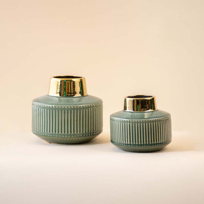 Green ceramic decor jars with gold lid accents and textured finish perfect for modern table or shelf styling in home decor setup.