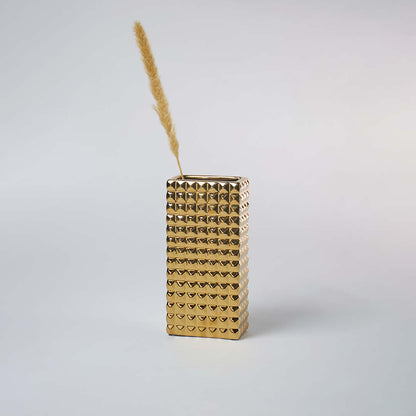 Modern gold textured vase placed in a minimal setting creating a bold metallic decor accent perfect for contemporary living spaces.