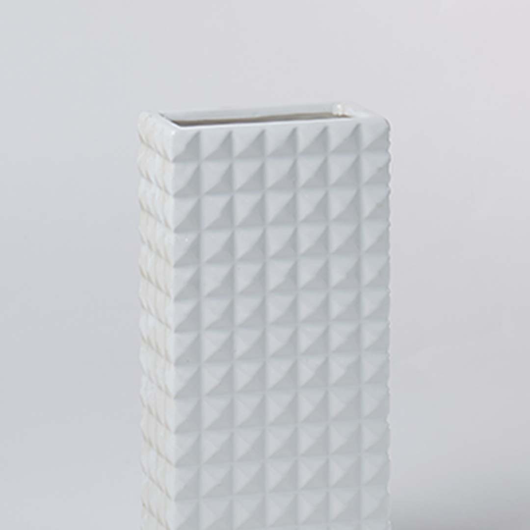Closeup view of the white textured ceramic vase highlighting its geometric pattern and smooth matte finish for elegant modern styling.