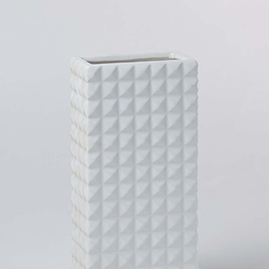 Closeup view of the white textured ceramic vase highlighting its geometric pattern and smooth matte finish for elegant modern styling.