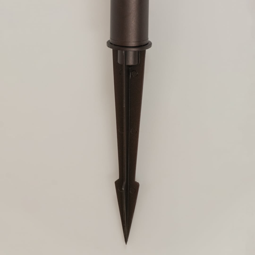 Closeup of brown solar garden lantern showing patterned glass panels and classic carved detailing ideal for warm decorative outdoor lighting.