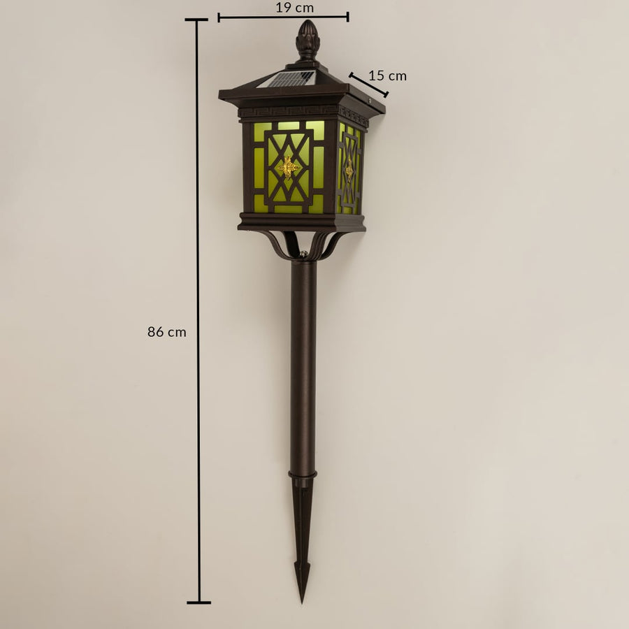 Brown solar garden spike lantern with patterned glass shown with 86 cm height 19 cm width and 15 cm depth providing accurate outdoor installation sizing.