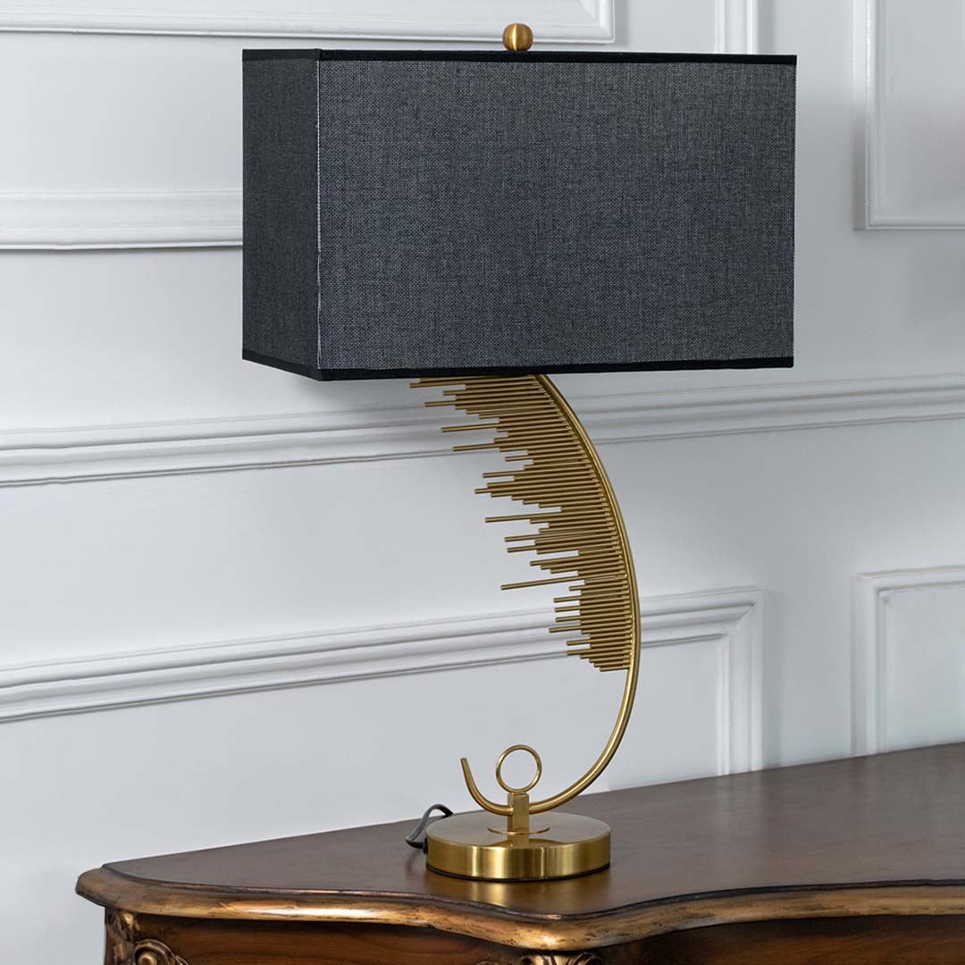 Gold artistic curved table lamp with black rectangular shade displayed on a white background perfect for luxury home styling and designer interiors.
