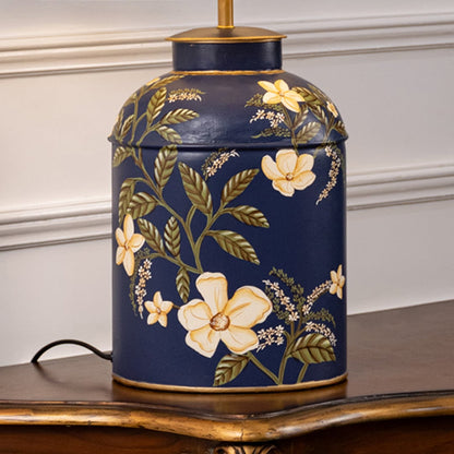 Table lamp closeup displaying dark ceramic base with golden floral artwork and refined decorative craftsmanship.