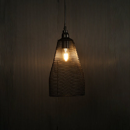 Elegant black mesh pendant hanging light illuminated against dark background highlighting its refined craftsmanship and industrial texture.