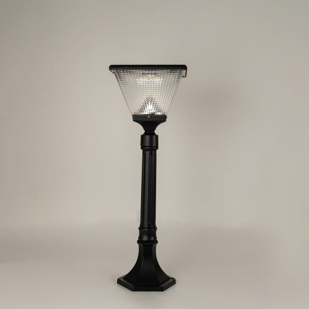 Modern black outdoor bollard light with textured glass shade for elegant exterior decor styling use.