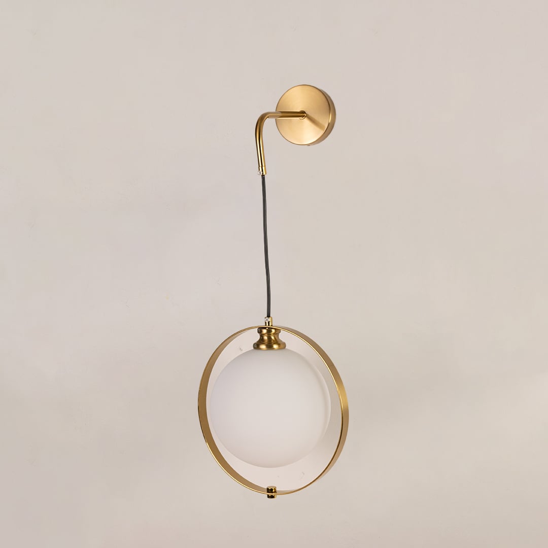 Gold ring wall light on a white background with the light off highlighting its sculptural minimal modern design.