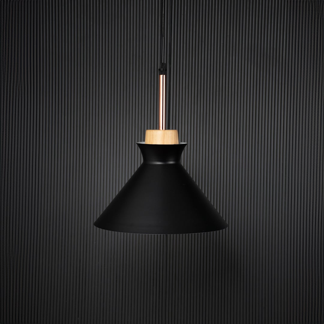 Black conical pendant ceiling light with wooden top switched off on back background for modern dining room cafe and living space lighting.