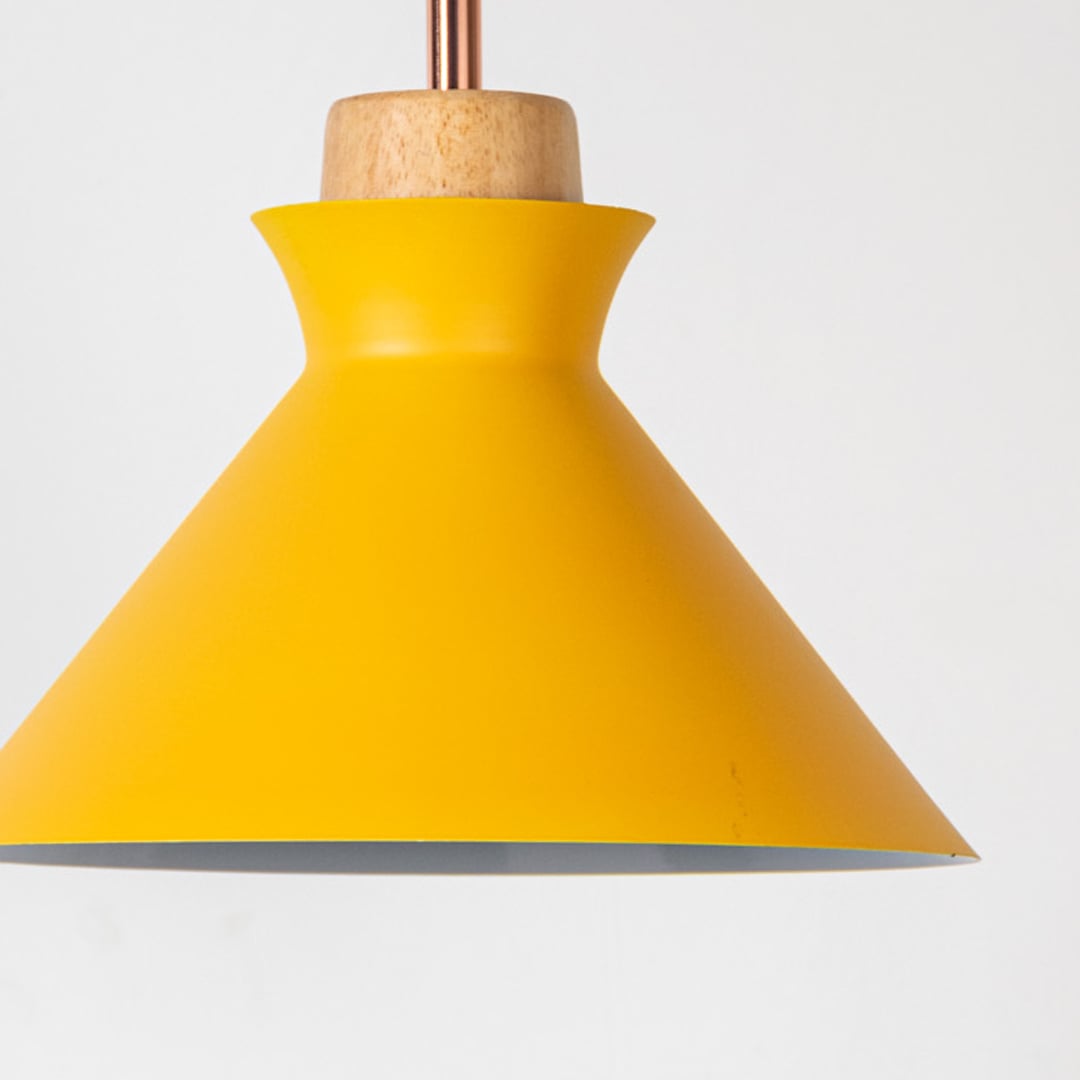 Closeup of yellow conical pendant ceiling light with wooden accent showing matte finish for modern dining kitchen and cafe lighting decor.