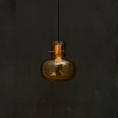 Elegant amber glass hanging pendant light displayed on dark background with light turned off for stylish look.