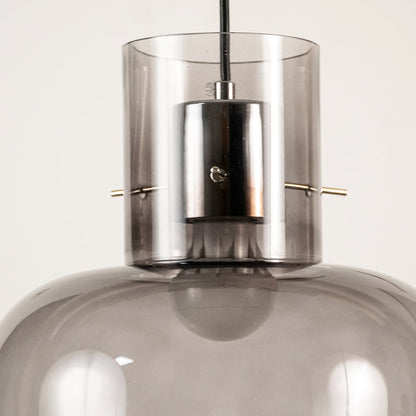 Close view of modern grey glass pendant light showing smooth glossy surface and refined craftsmanship details.