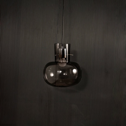 Contemporary grey glass hanging pendant light displayed on dark background with light turned off for elegant appeal.