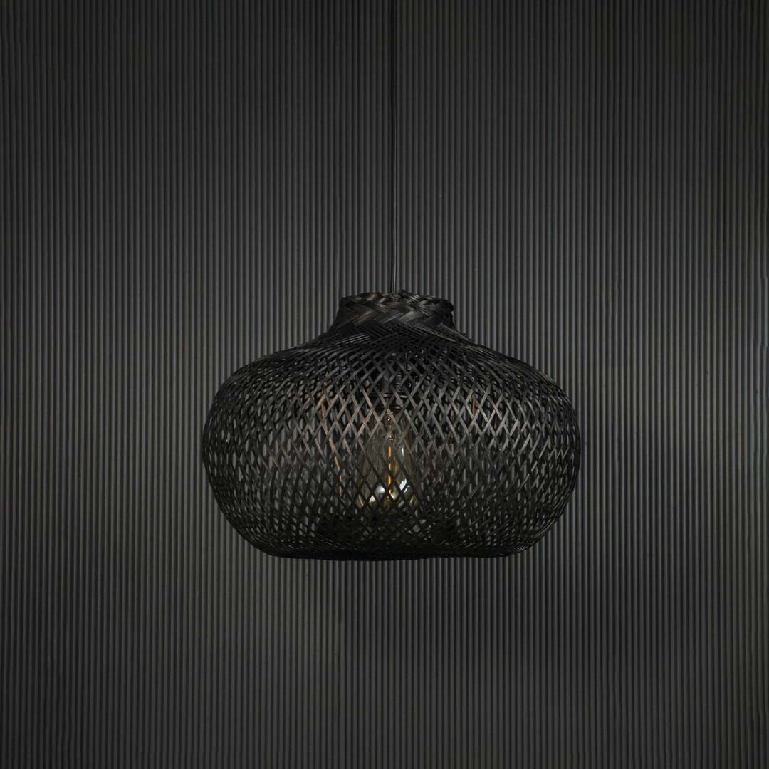 Black rattan pendant light hanging fixture with artisanal weave adding modern ambience to dining spaces.