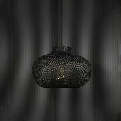 Black rattan pendant light hanging fixture with artisanal weave adding modern ambience to dining spaces.