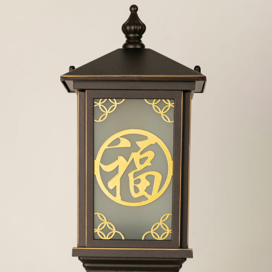 Closeup of brown decorative outdoor pillar lamp showing Chinese pattern frosted glass and clean metal detailing ideal for ambient garden lighting.