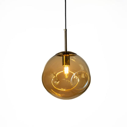 Amber glass pendant lamp glowing warmly on white background adding soft golden ambience to modern interiors.
