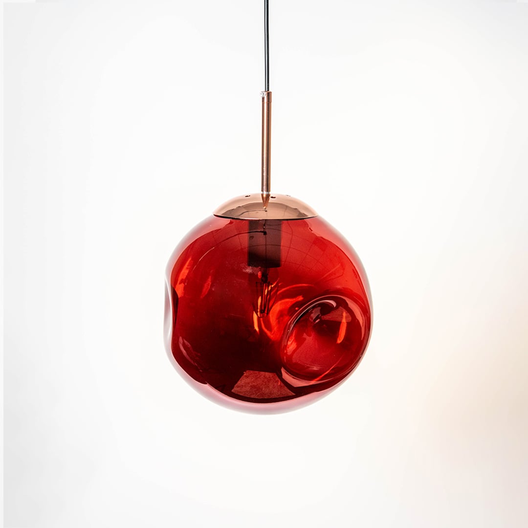 Red glass globe pendant light with golden holder displayed on white background perfect for stylish room lighting.